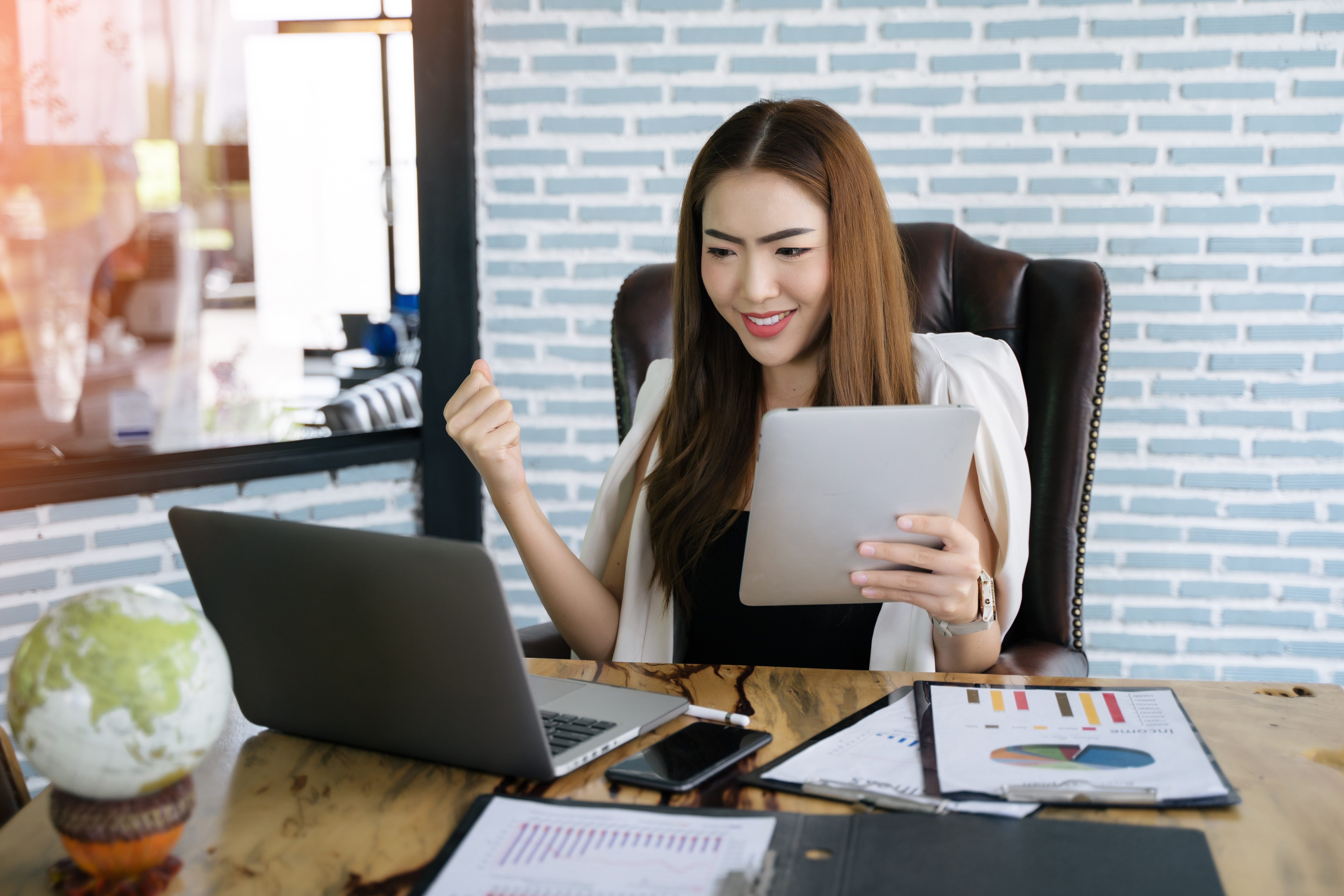 Woman business owner sitting at her desk